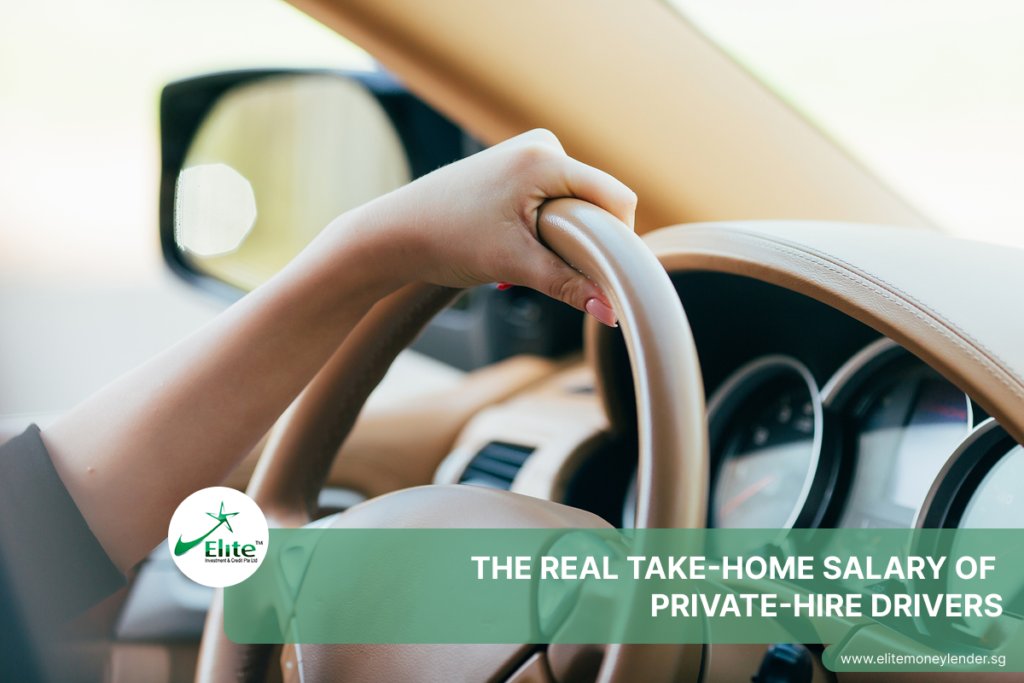 Private-hire driver's hand on steering wheel during a trip.